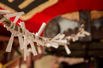 <p>A string of hung fortunes line the way from the lantern</p>
