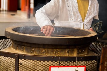 <p>A woman makes preparations to enter&nbsp;</p>