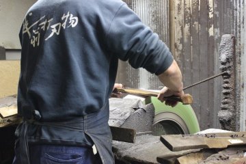 <p>This craftsman is sharpening the knives</p>