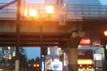 <p>There is&nbsp;a large intersection with a highway up above. Turn left. There will be a long crosswalk directly in front of you. Walk across to the other side</p>