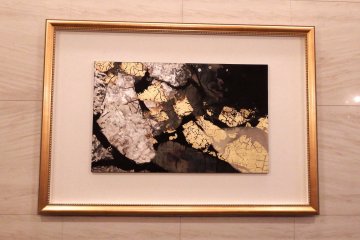 <p>A closer look at an abstract painting on the wall</p>