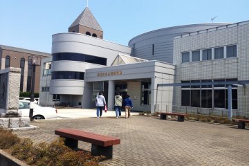 <p>The modern library building would be on your right as you head north, with the Gloria Chapel immediately north of the library</p>