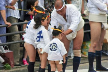 <p>Children participating with their grandfather; preschoolers generally run ahead of the floats</p>