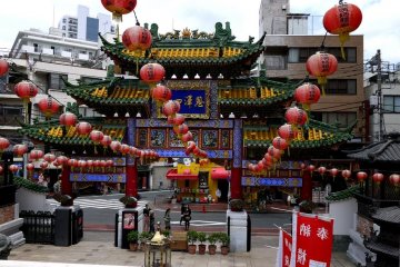 Red lanterns hang from lines attached to the gate