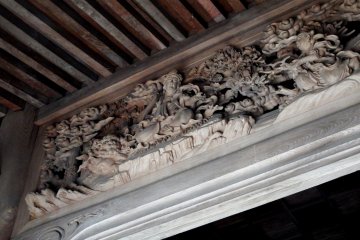 Intricate wooden carvings depicting Goddess of Mercy