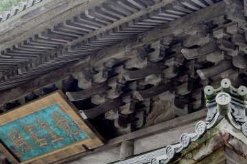 Close-up view of the intricate wooden architecture of Buddha Hall