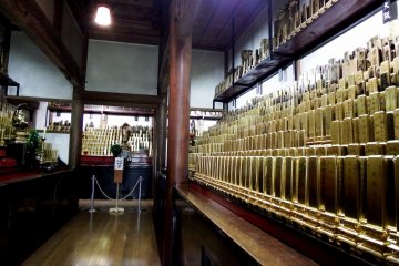 <p>There are many many many memorial tablets of followers lined up on a shelf</p>
