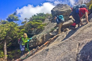 <p>The only way is up, by climbing along the rock face!</p>