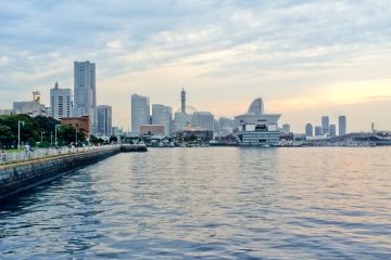 The late evening sun casting one last shadow on Yamashita Park with Minato Mirai in the distance