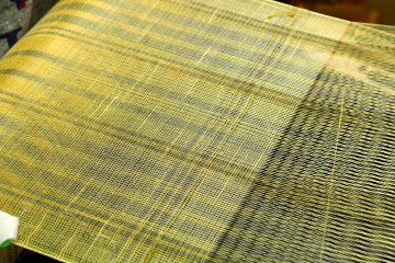 <p>Silk going through the loom in Furusato Mura</p>