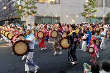 <p>Three generations side by side playing drums</p>