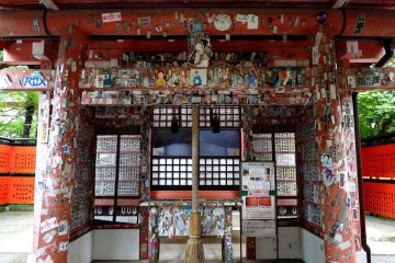 <p>Photos and name tags of artists, actors, dancers, singers are stuck all over this shrine</p>