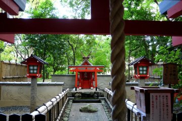 <p>Small red shrine set back from the main path</p>