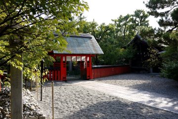 <p>Pretty red gate among the trees</p>