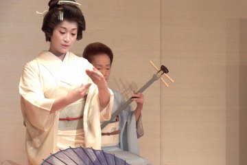 <p>What is she trying to express with her elegant hand movement?</p>