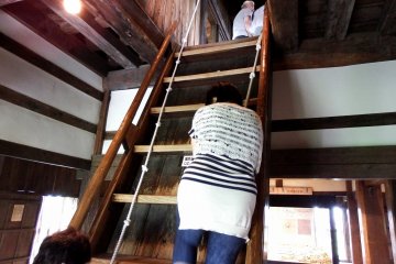 <p>Wooden stairs to get to the top of the main castle tower. It's so steep that visitors have to cling to the rope to climb up without tumbling down to the bottom</p>