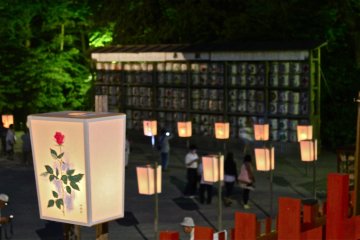 <p>Softly lit Bonbori against the wall of sake barrels.</p>