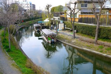 <p>Traditional style buildings contrast with modern high rise buildings on opposite sides of the canal</p>