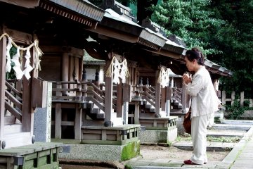 <p>This lady was praying fervently in front of each shrine</p>