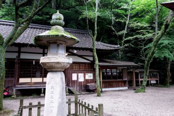 <p>Stone lantern and the administration office. This lantern was built in 1912</p>