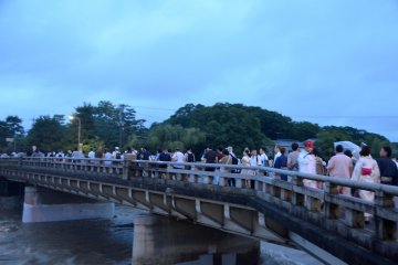 Scores of people heading to the banks of Kamo river despite the gloomy weather.