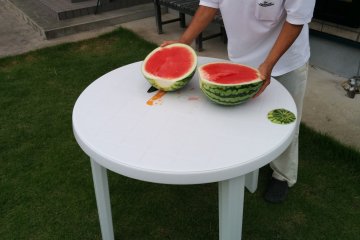 <p>Okui-san prepares the watermelon</p>