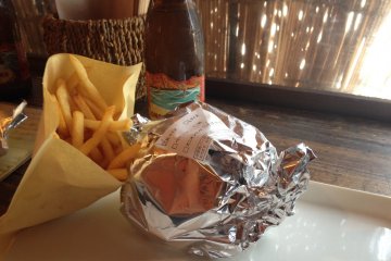 <p>Burgers arrive wrapped in foil to prevent any juices escaping</p>