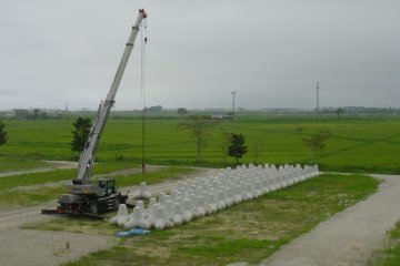 <p>Behind the school are some of the new defences that will be added by the shore. Inland, the ground is going to be raised by 3 metres, and Yuriage will be rebuilt.</p>