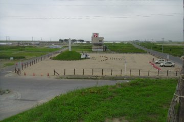 <p>The hill overlooks a new monument to those who died. The building in the background (a former business) will be preserved, whether this area becomes a nature reserve, a solar park, or something else.</p>