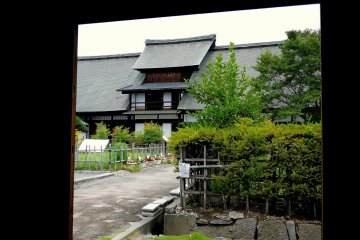 <p>View of the big house framed by the gate</p>