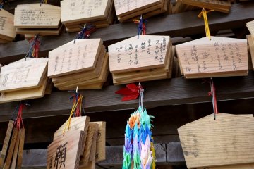 <p>The wooden ema tablets at the shrine seem to have more than one word on them</p>