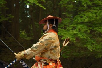 An archer readies his bow and arrow