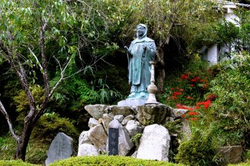 <p>Temple statue with a splash of red in the background</p>