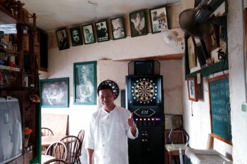 <p>Side seating area and darts board</p>