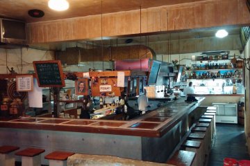 <p>Rear view of the large bar and kitchen area</p>