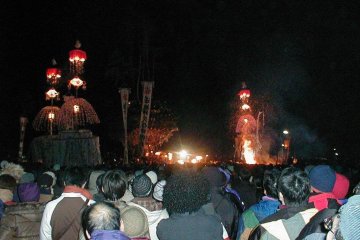 <p>The pyre, prior to it burning. The flames below are torches held by the attacking men.</p>