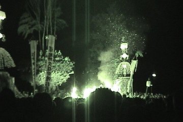 <p>In this night vision shot you can see the men on the top of the pyre. What looks like lines of smoke above them is actually bamboo, stuck into the top of the pyre.</p>