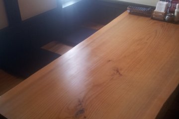 <p>The table is a solid slab of timber</p>