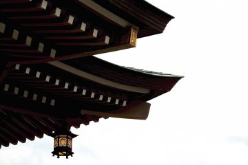 <p>Shrine roof and lit-up lantern in the late afternoon</p>