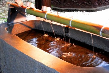 <p>Lit-up purification font at dusk</p>