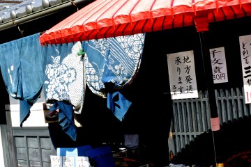 <p>A noren in traditional Japanese blue tied up to let customers pass into the shop more easily</p>