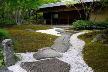 <p>Paving stones set in white sand resemble a river with rocks</p>