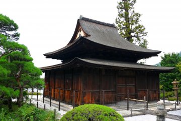 <p>Wooden building with gracefully shaped roof</p>