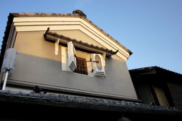<p>Thick shutter windows wide open to let heat trapped in the building escape</p>
