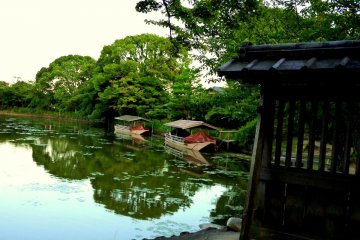<p>The trees are reflected in the pond's still water</p>