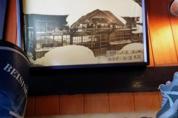<p>A picture of an older version of the bath house during winter</p>