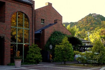 <p>The shop and cafe are housed in a graceful red brick building. You can see Omihachiman's cable car in the background.</p>