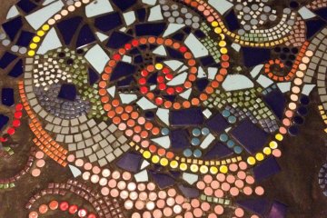 <p>Mosaic stairs guide you down to the cafe</p>