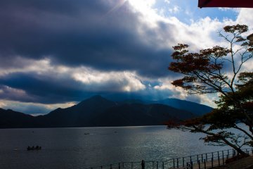<p>Sunrays break through the clouds over Chuzenjiko.</p>