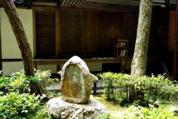 <p>A small bookshelf on the balcony with Buddhist literature</p>